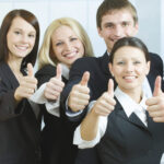 Cheerful business people showing that everything is OK